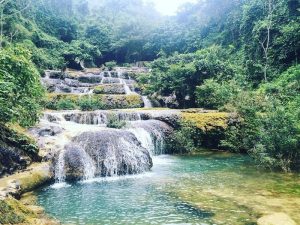 Clear turquoise water flows down unique limestone tiers at Hieu Waterfall in Thanh Hoa